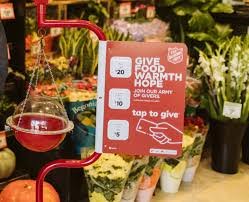 a picture of a Christmas stand with collection bubble and tap to give sign