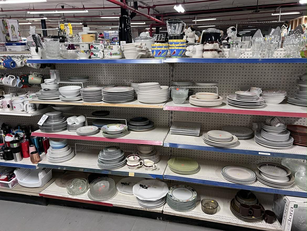 A picture of shelves full of donated dish sets